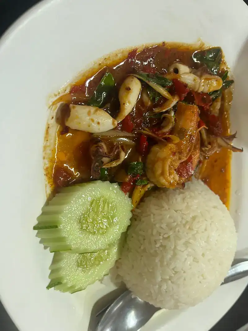Squid and prawn stir-fried with chilli, with rice and cucumber on the side