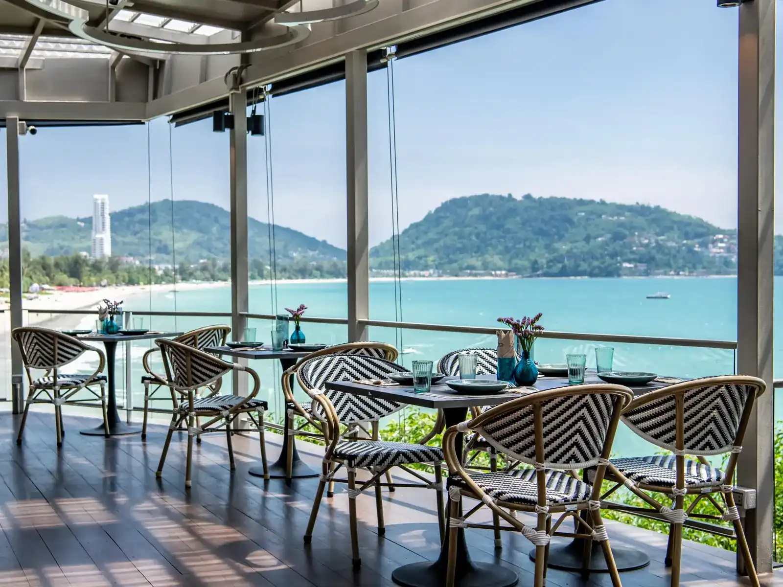 Tables on the terrace, looking across Patong bay to the hills