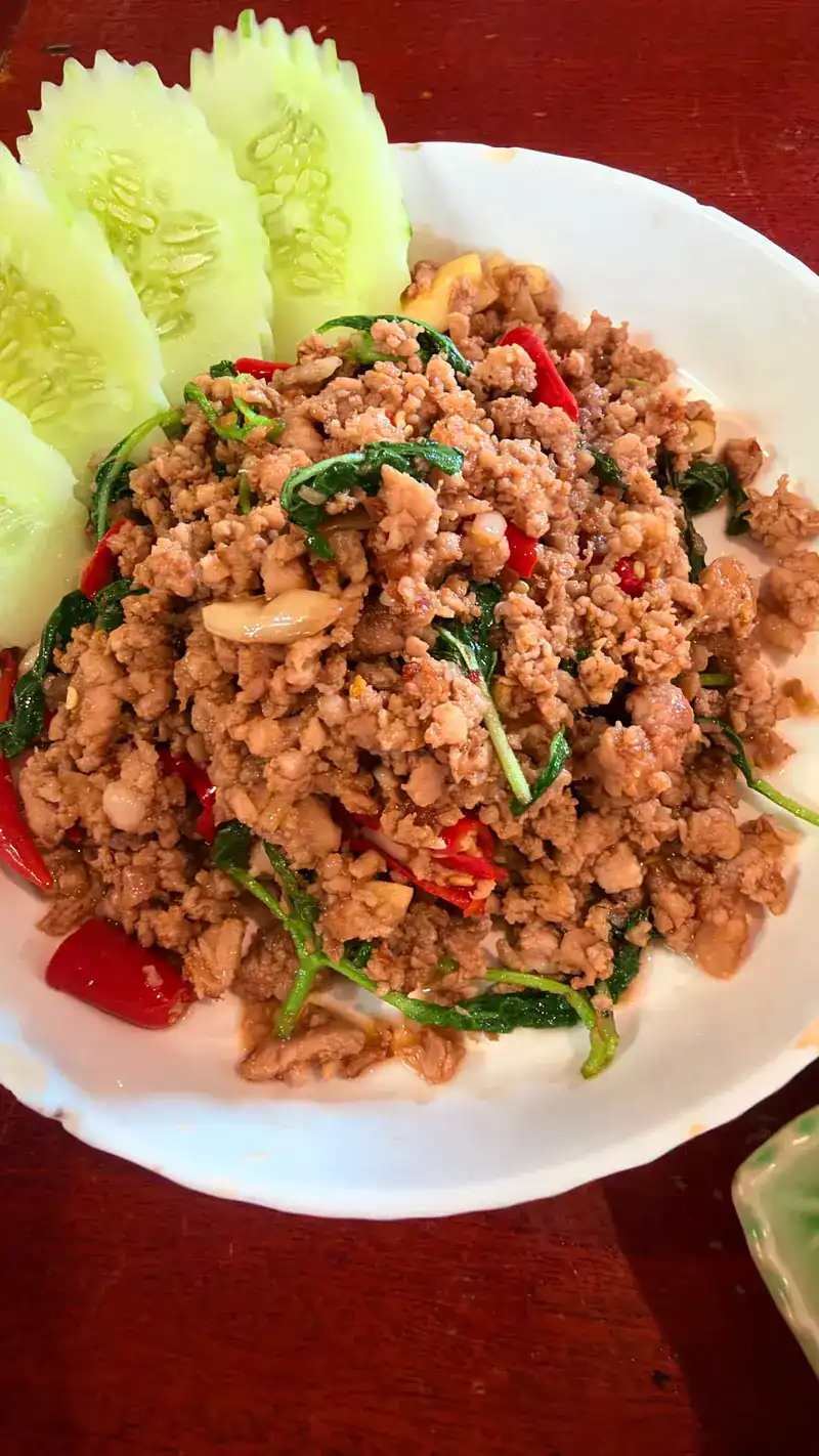 Minced meat stir-fried with holy basil and chillies, with sliced cucumber