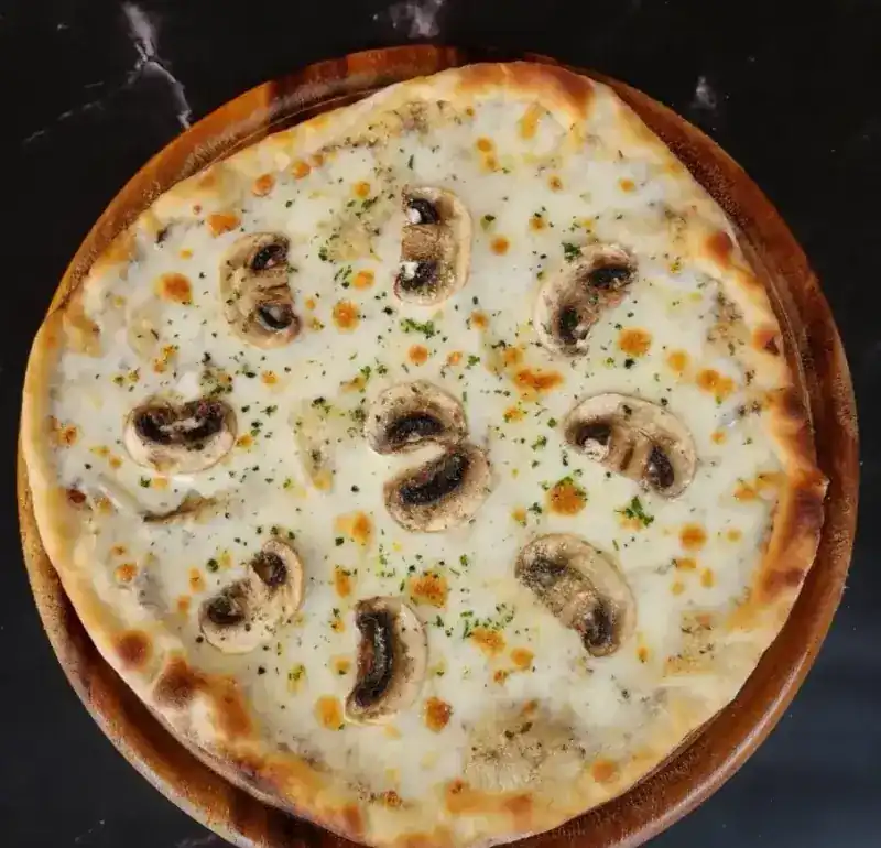 Truffle pizza with mushrooms on a wooden board