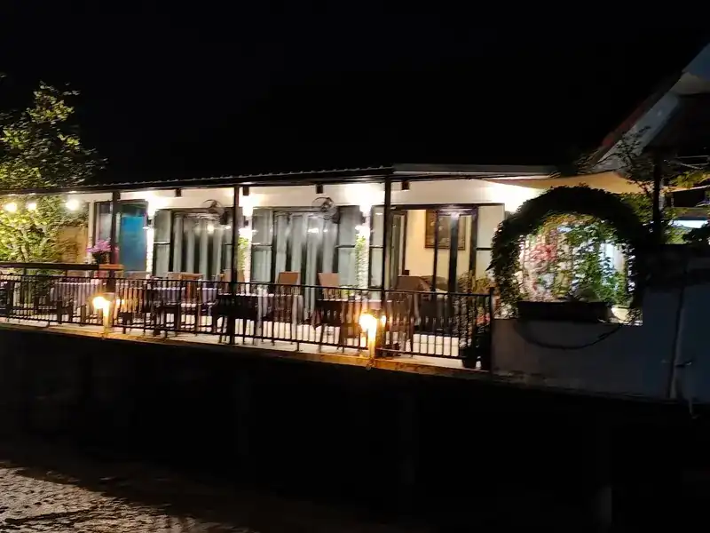 The deck lit up at night, seen from outside