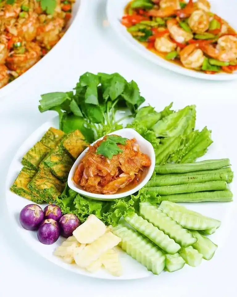 Chili dip with fresh vegetables, long beans, cucumber and squares of omelette