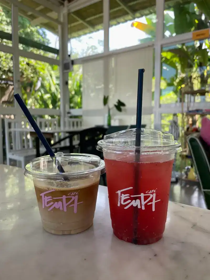Two iced drinks in Tempt cups on a marble table