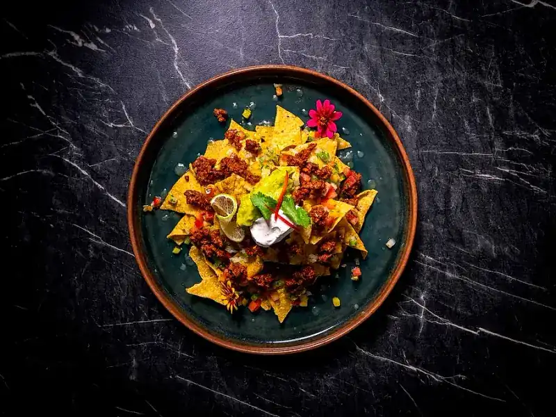 Nachos with minced meat, salsa and sour cream