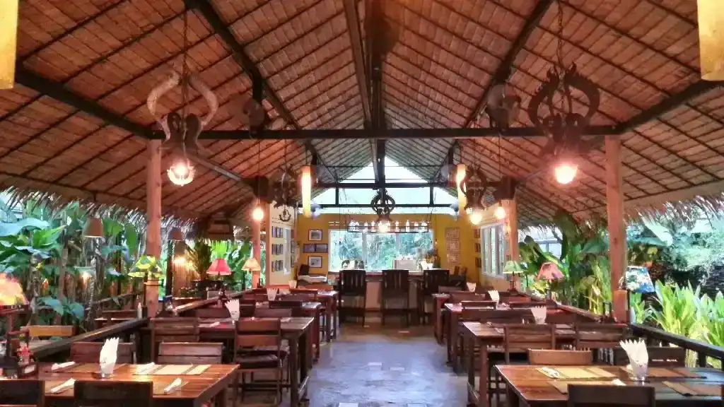 The open-sided dining sala at Sala Mexicali Rawai, wooden tables under a high roof