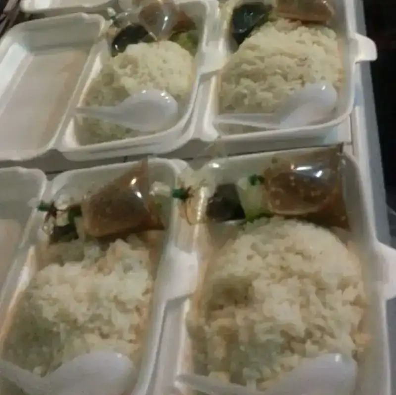 Chicken rice packed in foam boxes with the sauce in small tied bags