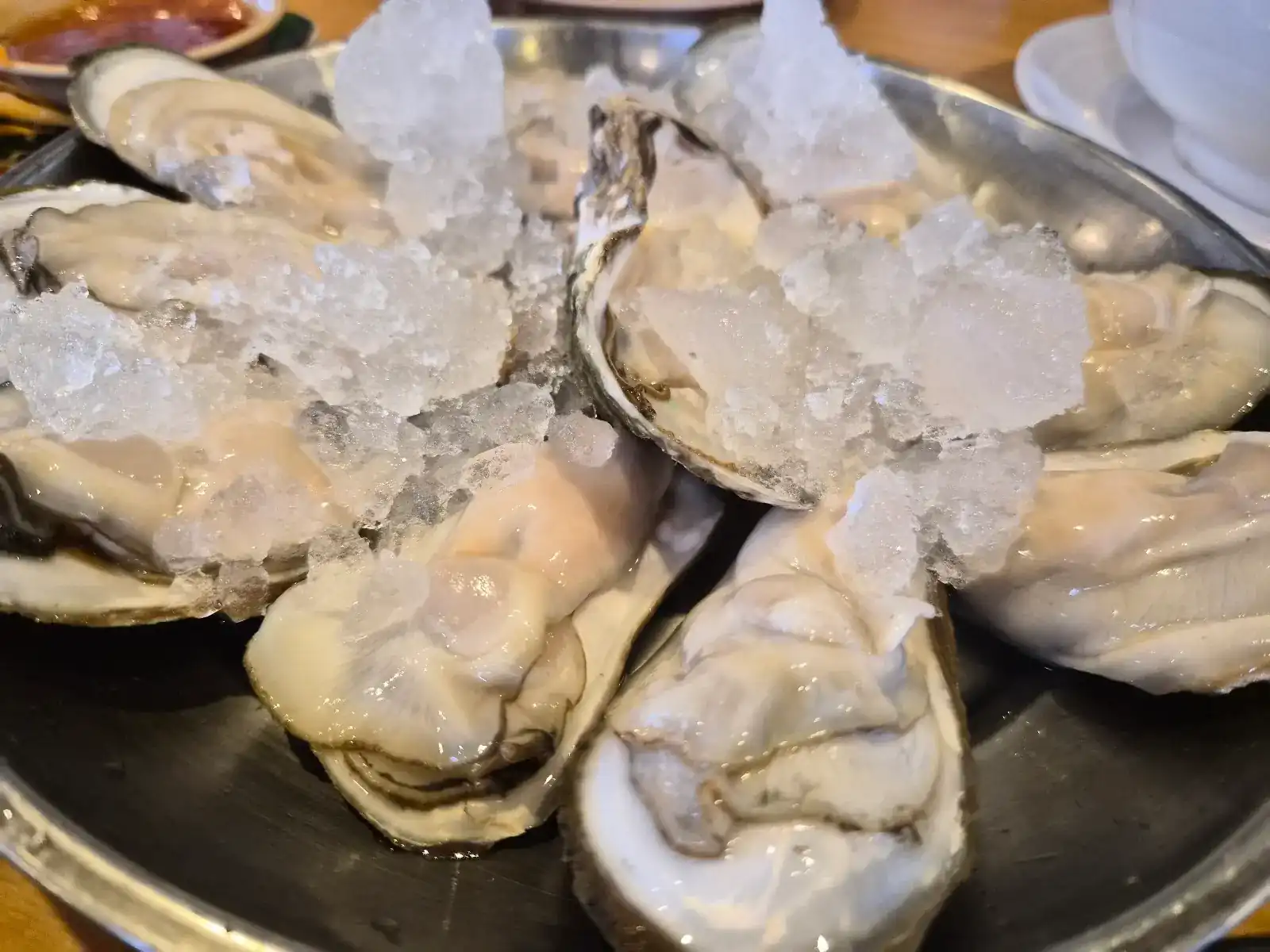 Raw oysters on crushed ice in a steel tray
