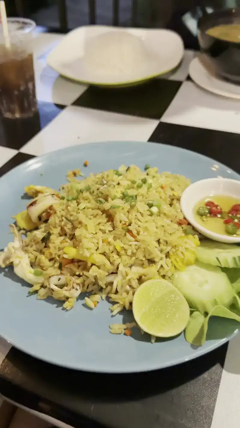 Fried rice with lime, cucumber and chilli fish sauce on a chequered table