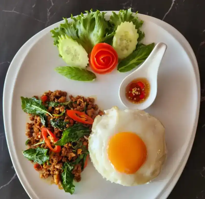 Pad Kra Pao with rice and a fried egg