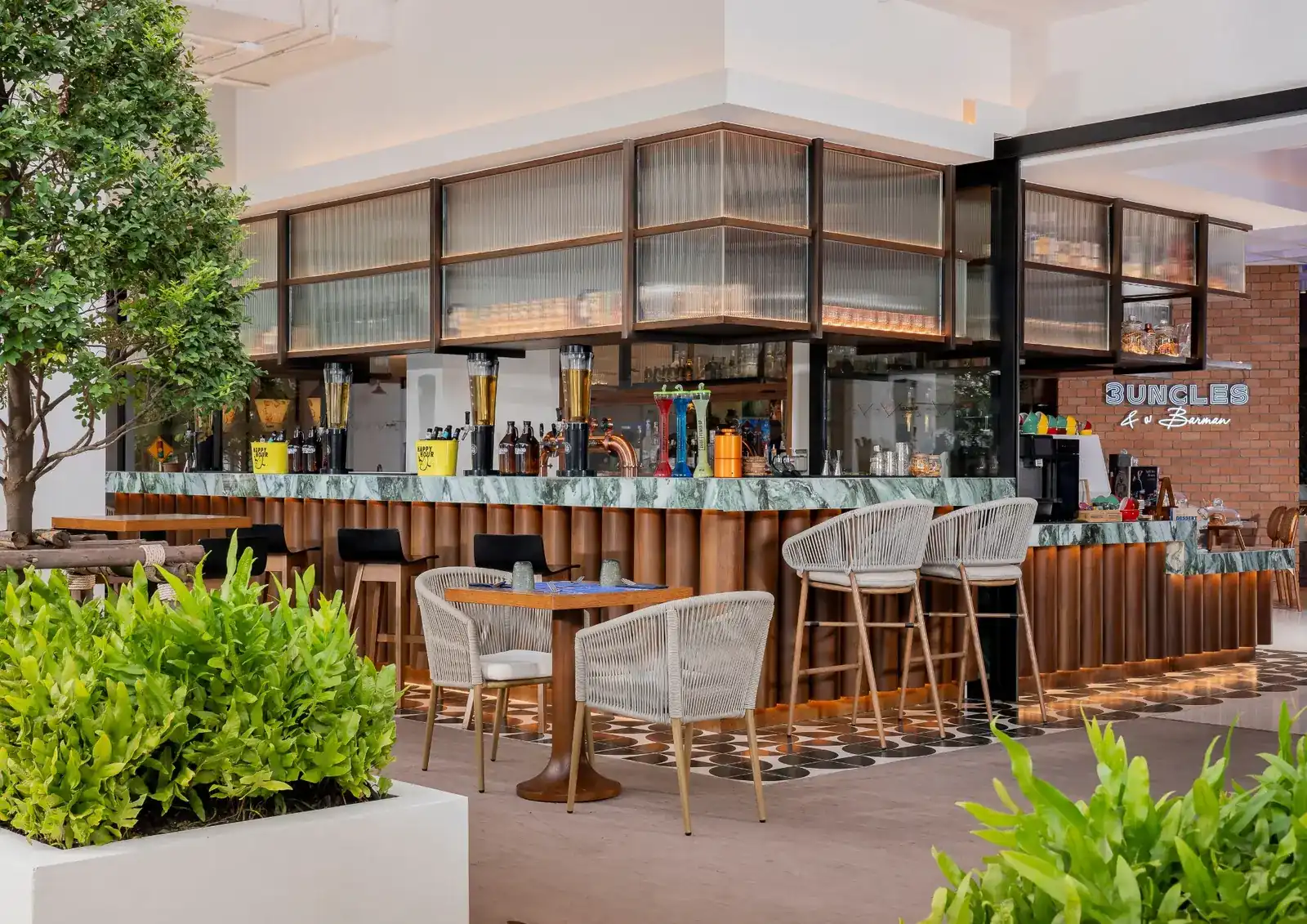 The island bar with its green marble counter, woven bar stools and terrace tables