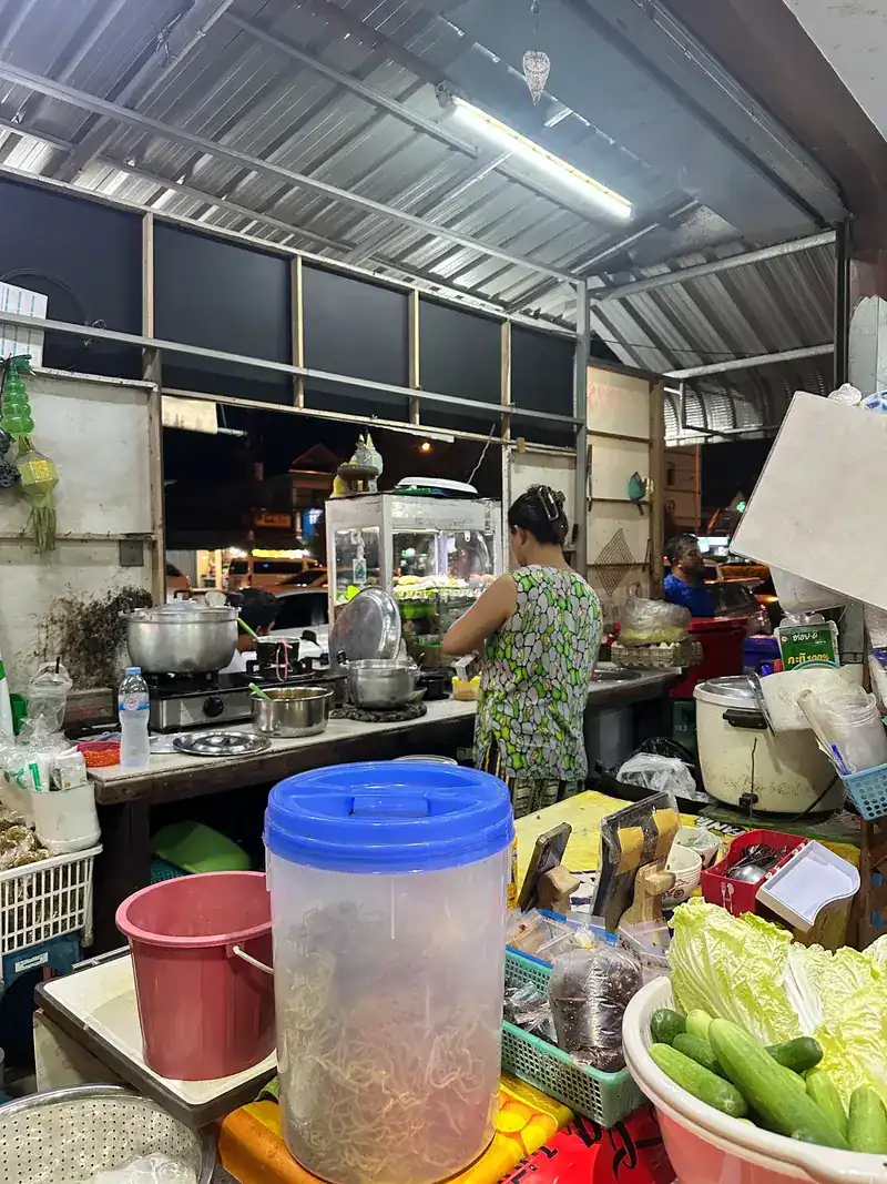 The open kitchen, with cabbage and cucumbers ready on the counter