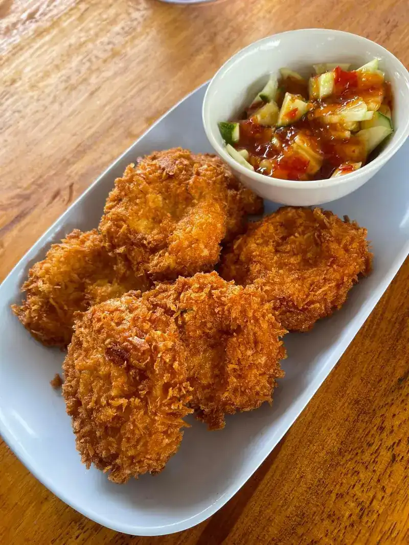 Crumbed fried cakes with a cucumber and chilli dip