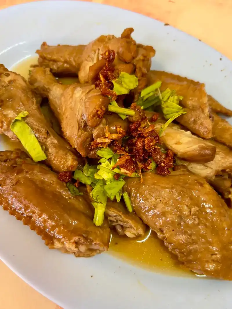 A plate of braised wings with chilli and Chinese celery on top