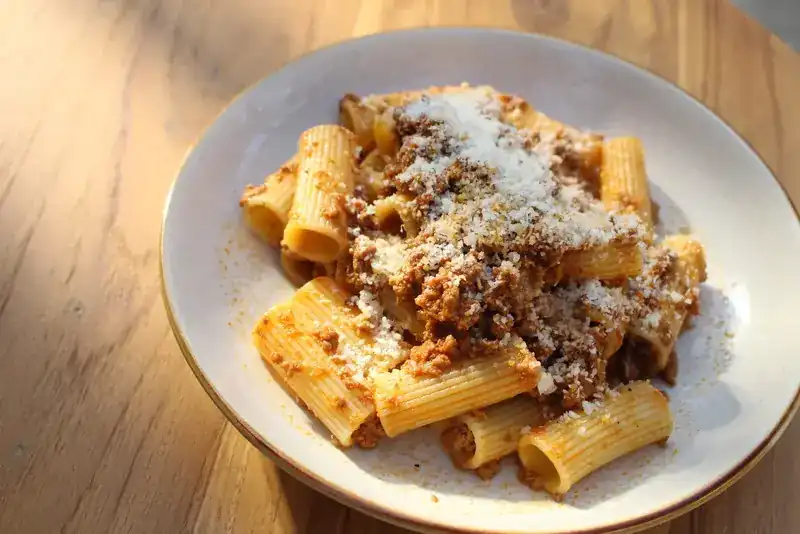 Rigatoni with beef ragu and grated cheese