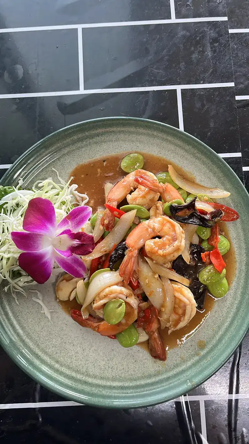 Prawns stir-fried with sator beans, chilli and onion, with a purple orchid