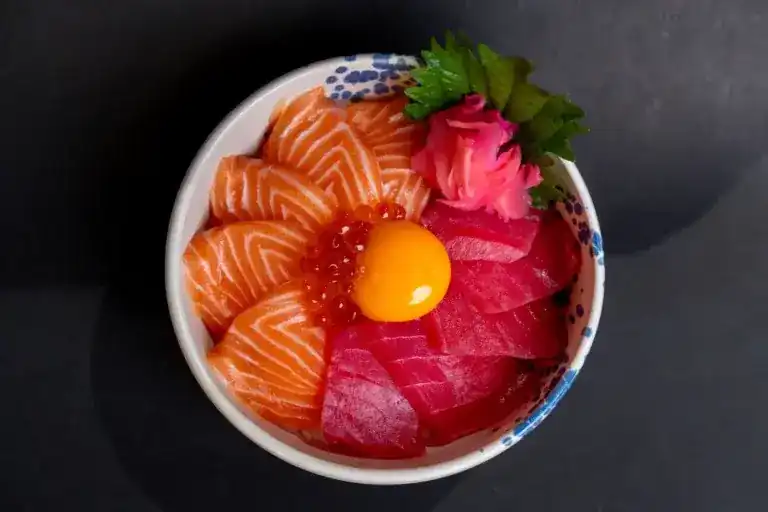 Sashimi rice bowl with salmon, tuna, salmon roe and egg yolk