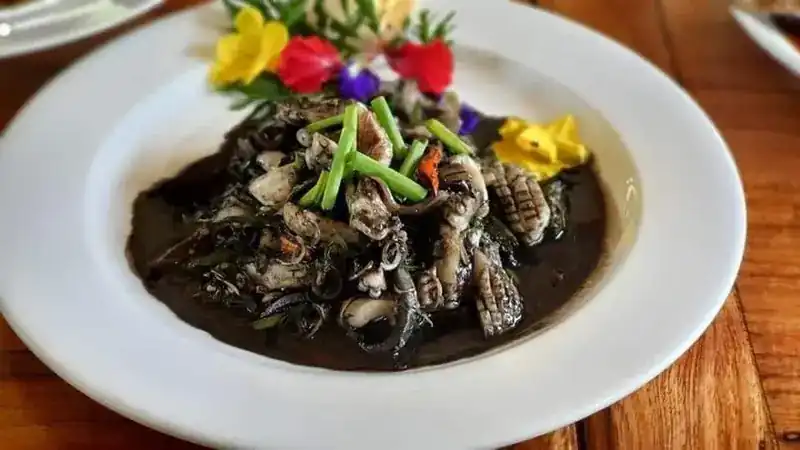 Squid in black ink sauce, topped with flowers