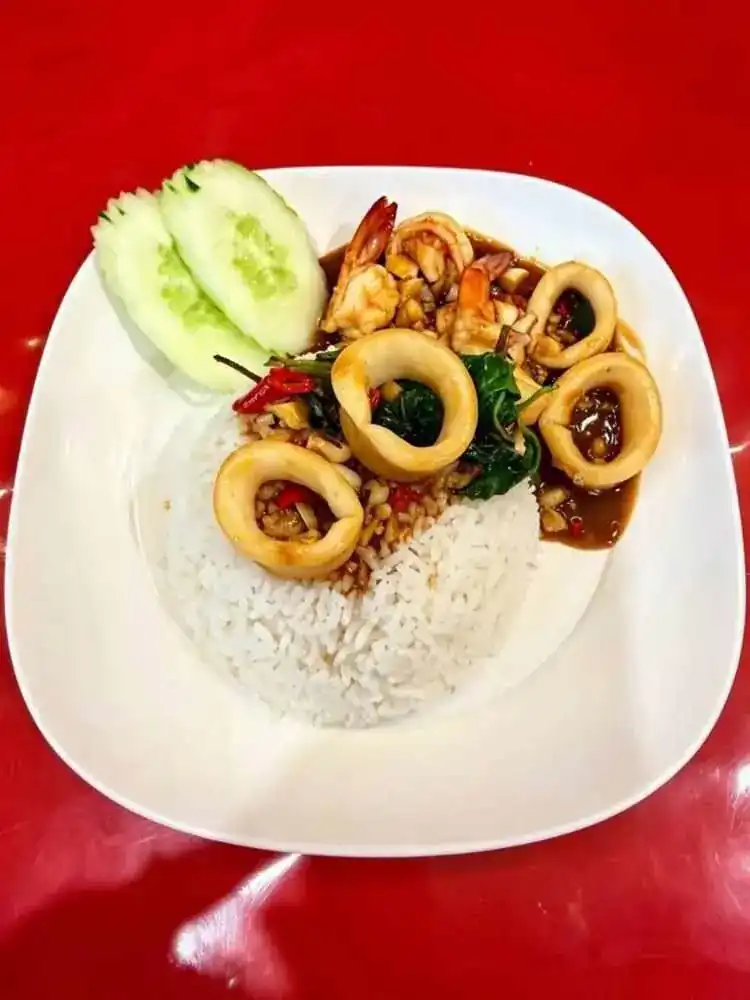 Squid and shrimp stir-fried with holy basil over rice