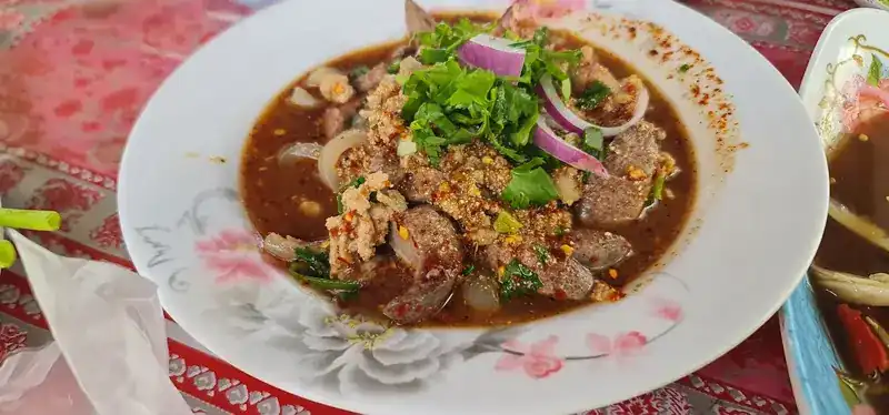A spicy dish of liver with herbs, red onion and roasted chilli
