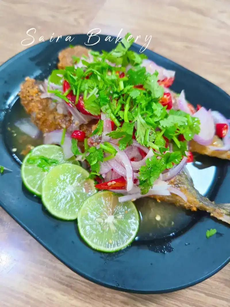 Fried fish under sliced lime, red chilli, shallot and coriander