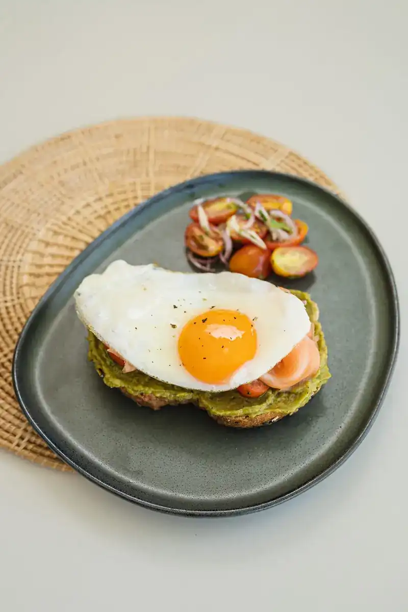 Avocado toast topped with a fried egg