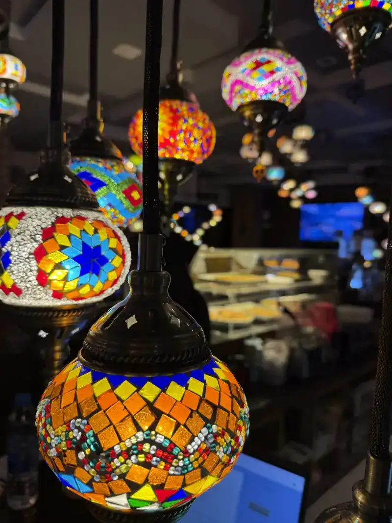Turkish mosaic glass lamps glowing in the dining room