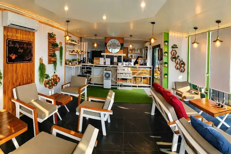 The café's counter and lounge chairs under pendant lamps