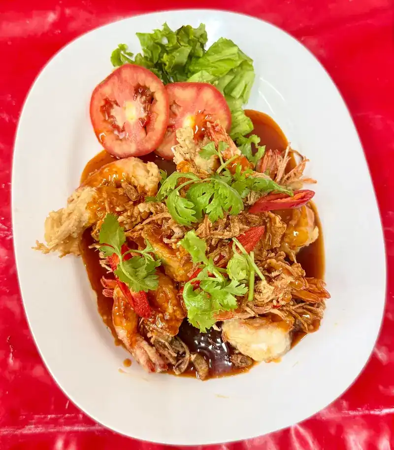 Prawns in a glossy brown sauce with crisp shallots, chilli and coriander