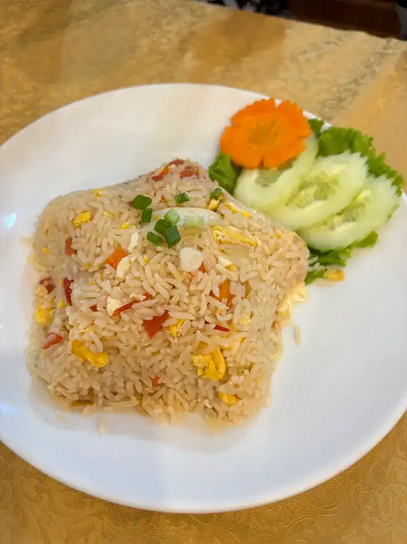 Fried rice with cucumber slices and a carrot carved into a flower