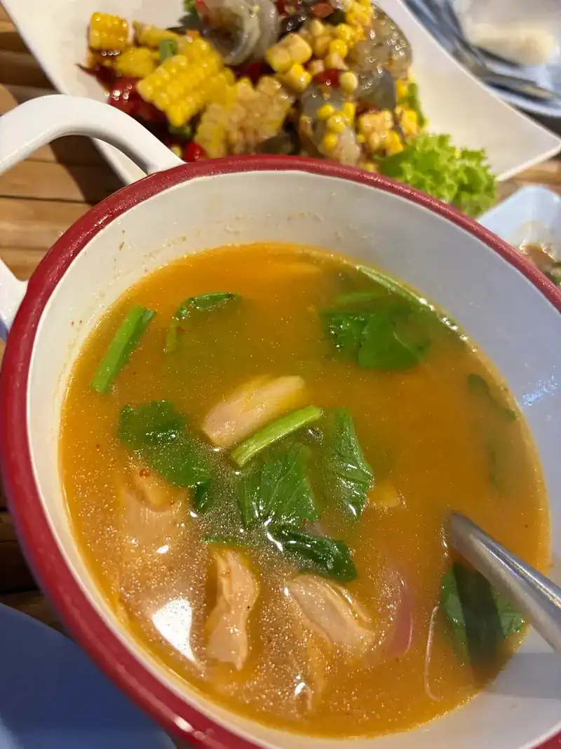 A bowl of soup with greens