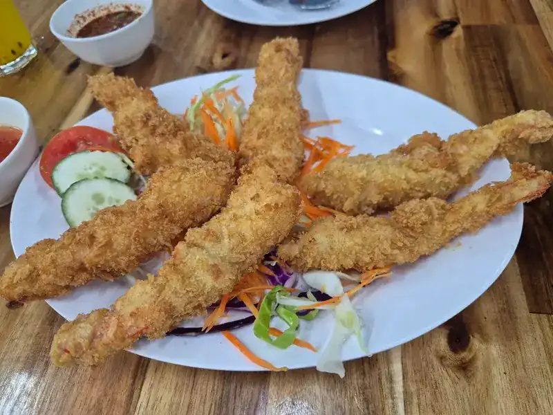 Crumbed fried prawns with salad and dipping sauces