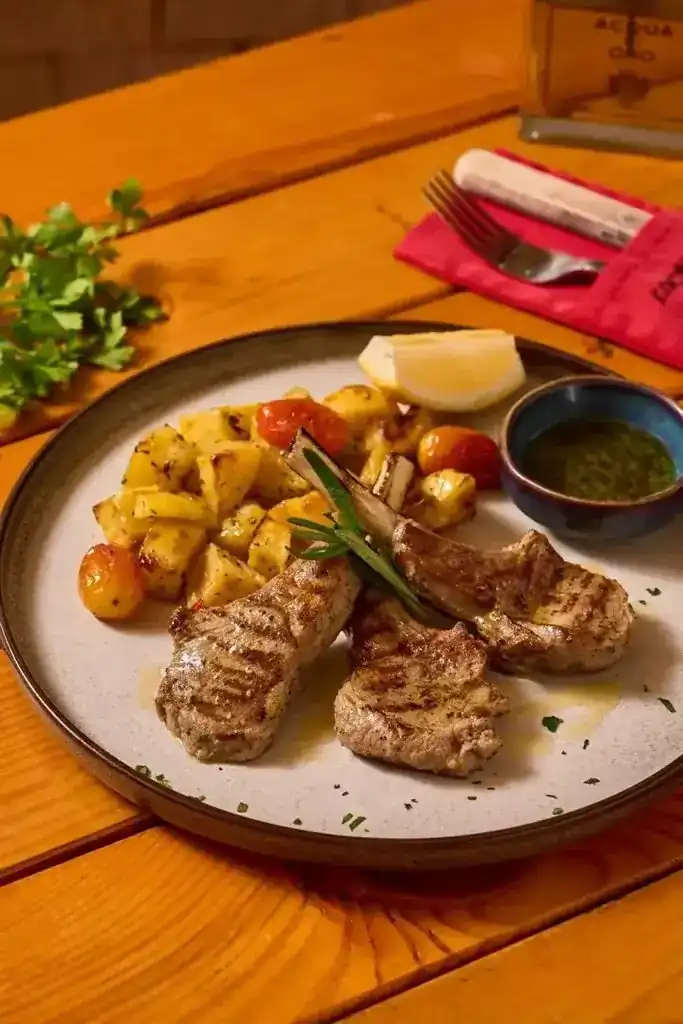 Grilled meat with roast potatoes, rosemary and lemon