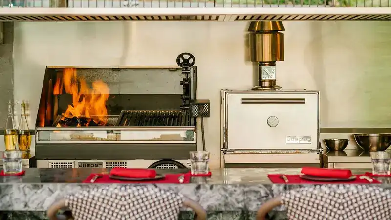 Flames in the Josper grill beside the Josper oven, behind the counter