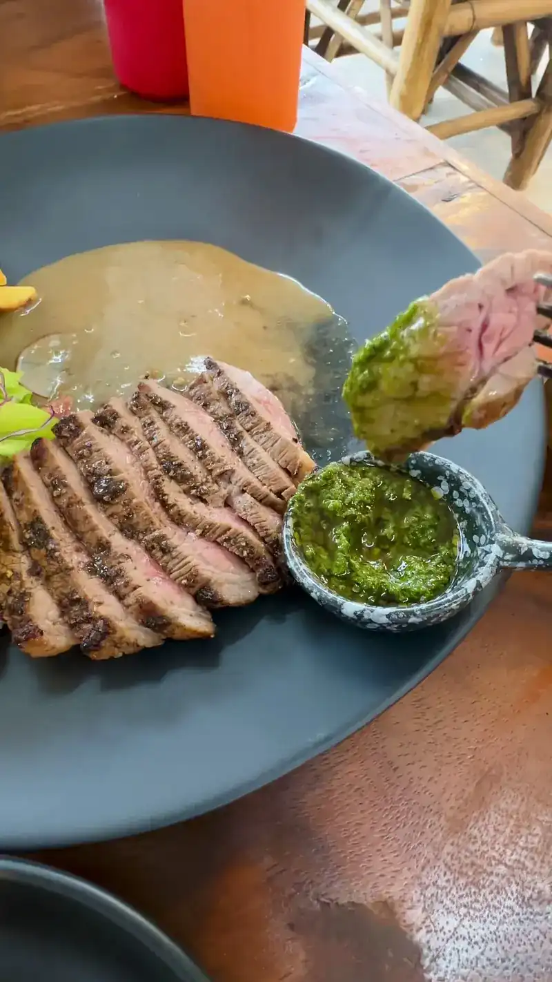 Sliced beef with a green herb sauce and a cream sauce