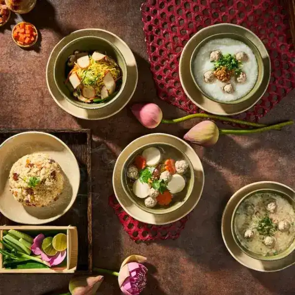 Soups and small plates laid out with lotus buds