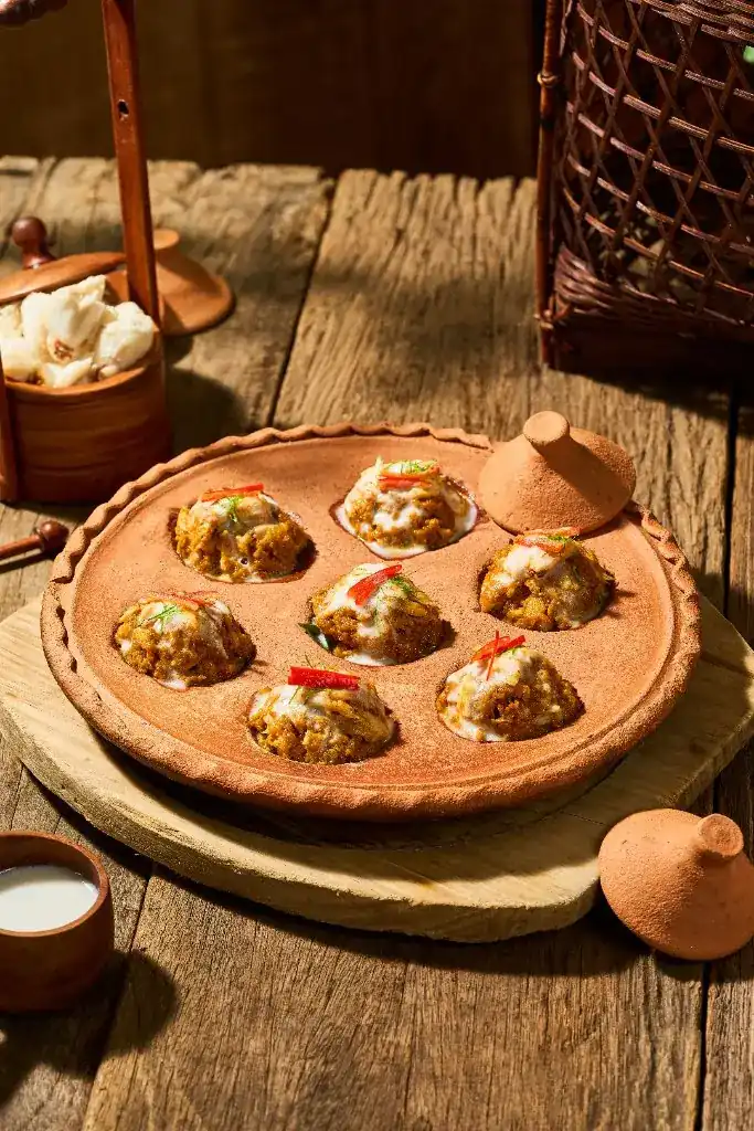 Seven small portions cooked in a clay pan with little lids