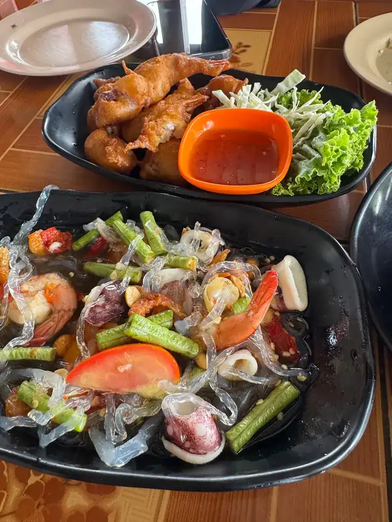 Spicy glass-noodle salad with shrimp, squid and long beans, fried chicken with a chilli dip behind