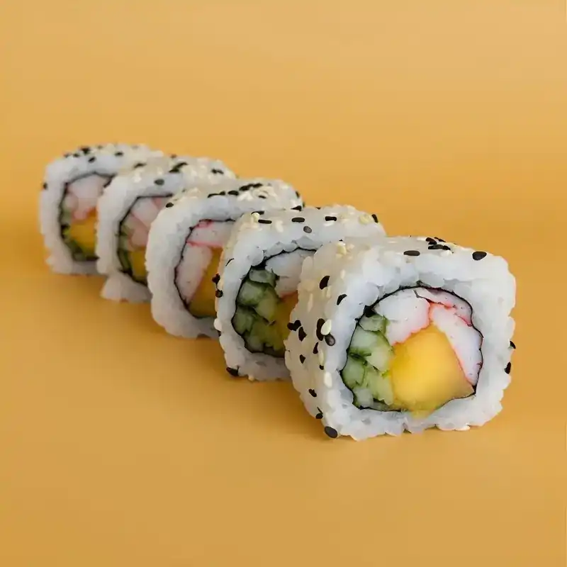 Sesame rolls with crab stick, mango and cucumber on an orange background