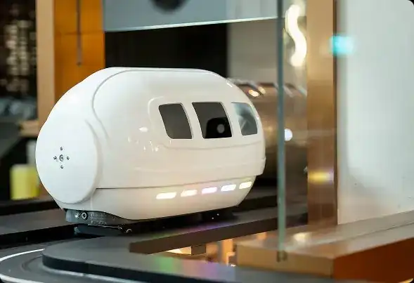 The white food capsule that carries dishes along the track at Shabu In