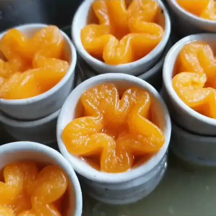Golden pinched egg-yolk sweets in small white cups