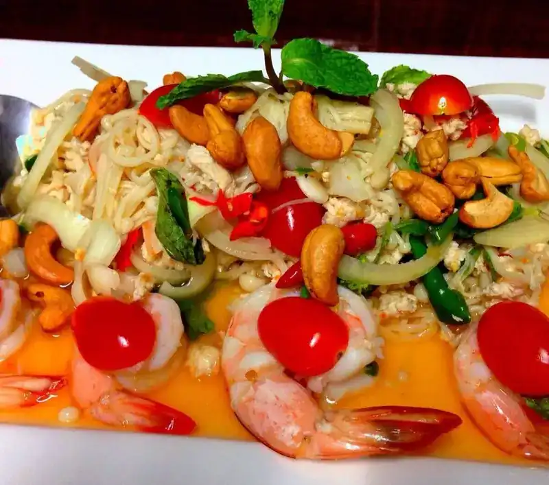 Spicy salad of shrimp, cherry tomatoes and cashew nuts with mint