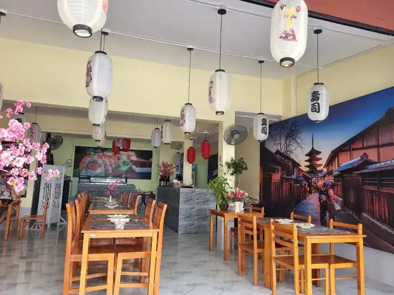 Dining room with paper lanterns, cherry blossom and a mural of an old Japanese street