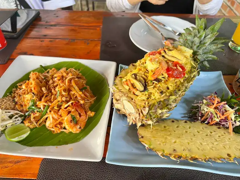 Pad thai with prawns, and fried rice served in a halved pineapple | ผัดไทยกุ้ง และข้าวผัดในลูกสับปะรดผ่าครึ่ง