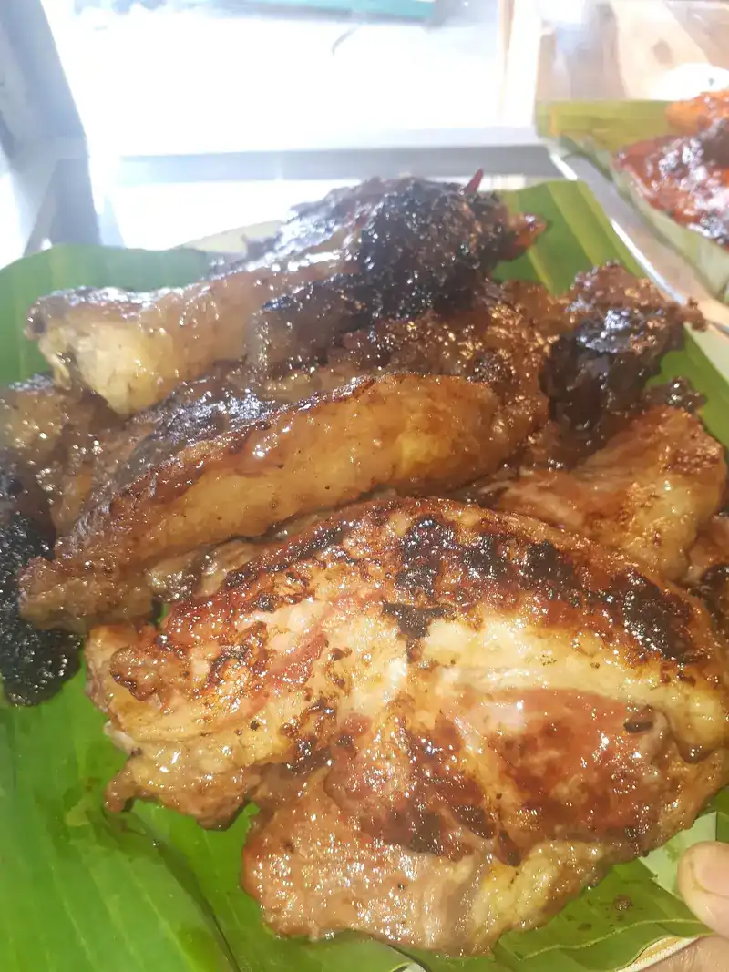 Pieces of grilled chicken on a banana leaf