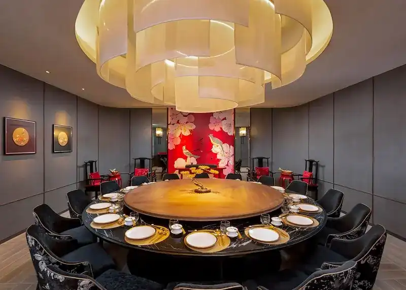 The large private room, a round table under a layered paper lantern ceiling