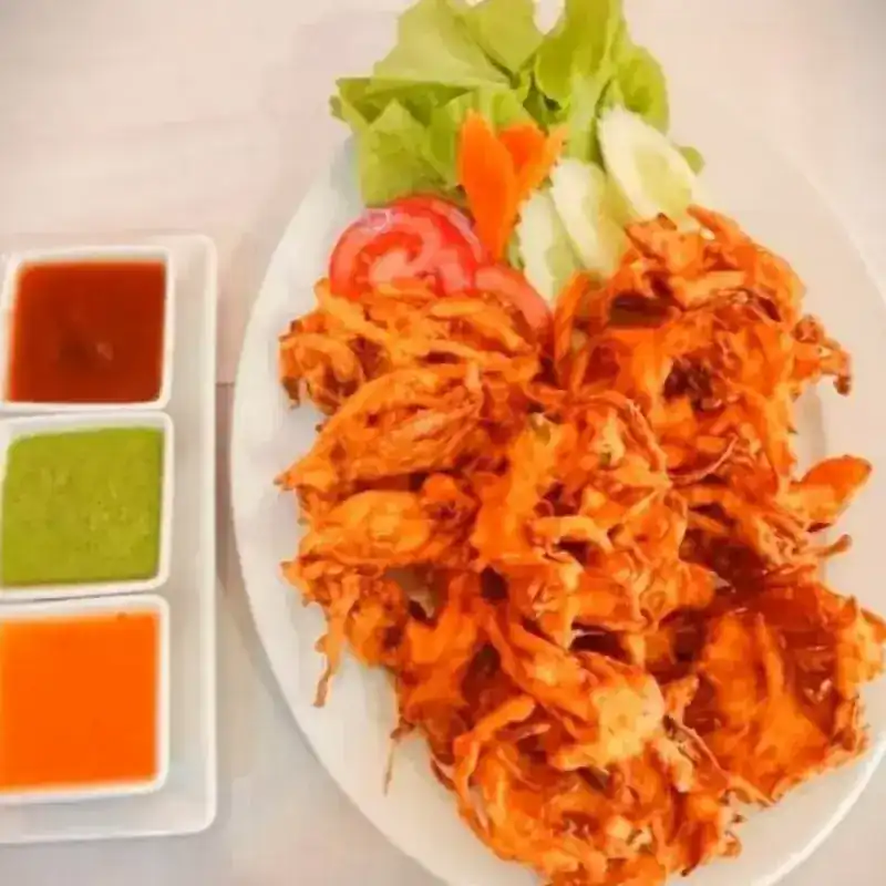 Onion fritters with three dipping sauces and salad
