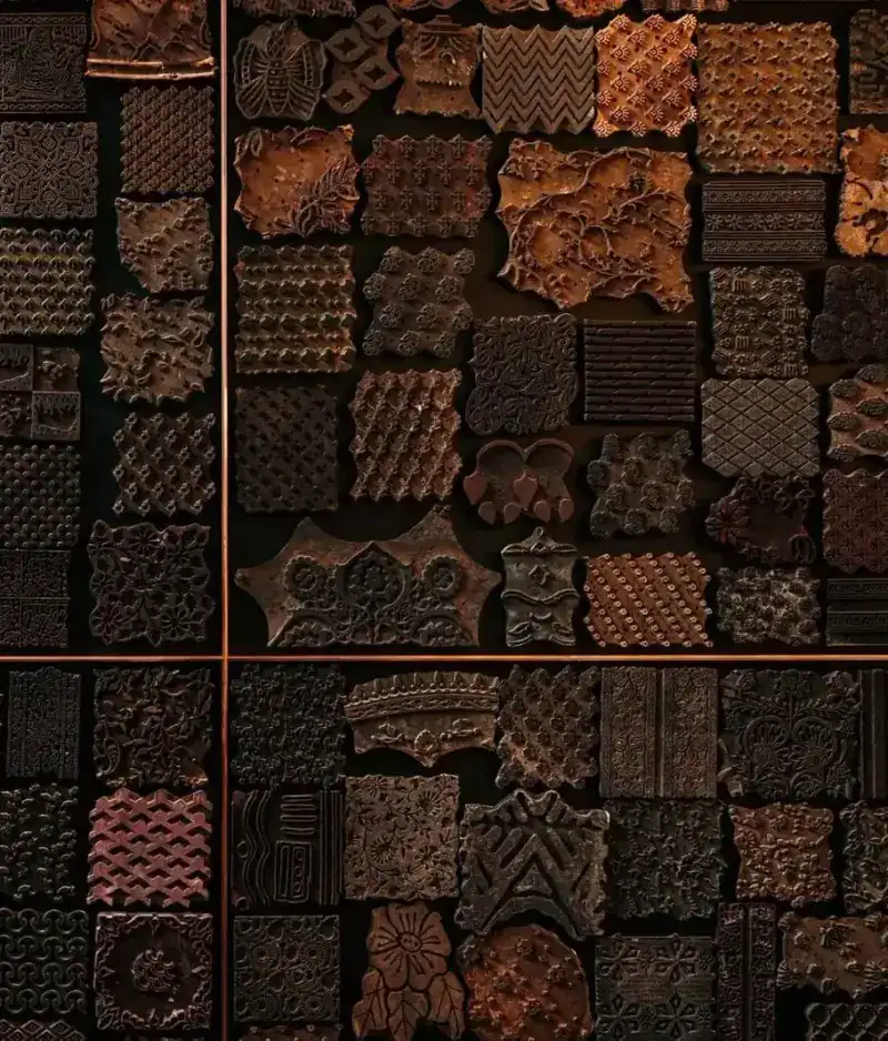 A wall of carved wooden blocks set in copper lines