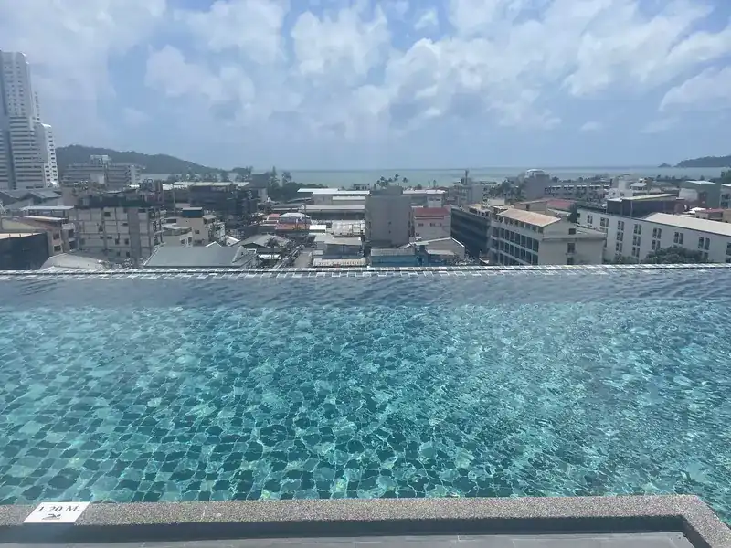 The rooftop infinity pool, with Patong town and the sea beyond