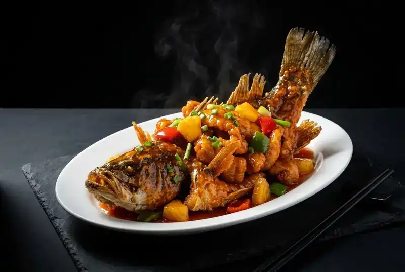 Whole deep-fried grouper in sweet and sour sauce with pineapple and peppers