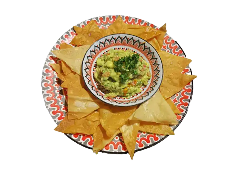 Nachos around a bowl of guacamole